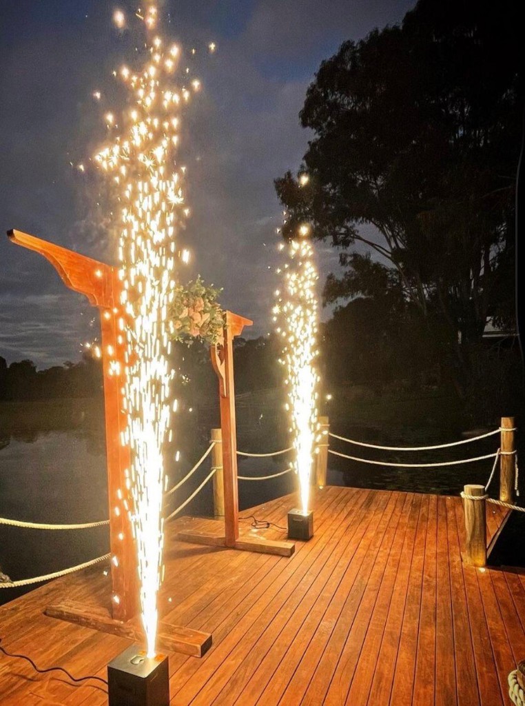 Dry spark machines creating spark fountains at an outdoor event