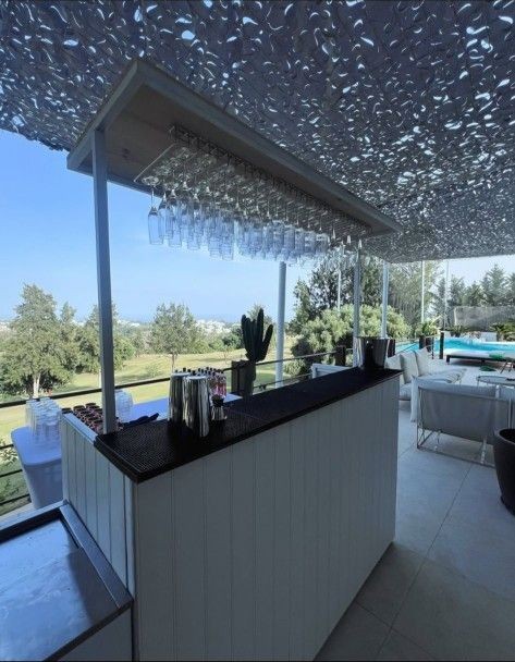 Outdoor bar with glassware hanging above the counter