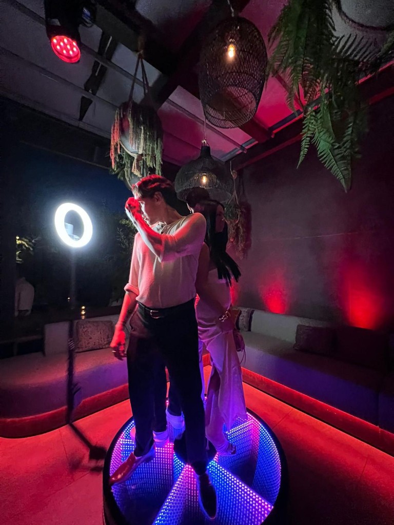 360 degree photo booth with guests on a glowing platform