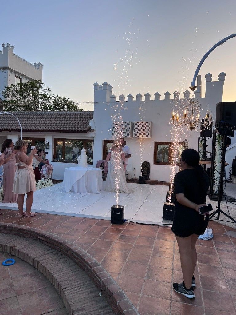 Wedding couple on a starlit dance floor with cold spark fountains